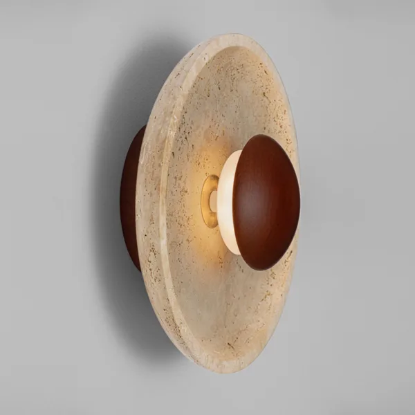 Side view of the round wall lamp showing the shallow travertine dish, the centre dome and the LED behind it