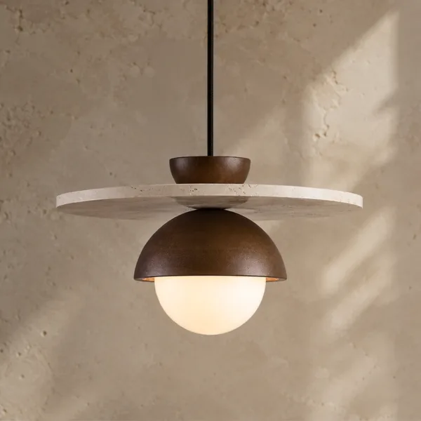 Travertine hanging light glowing: a cream travertine disc over a walnut-tone wood dome and opal borosilicate glass globe, against a stone wall