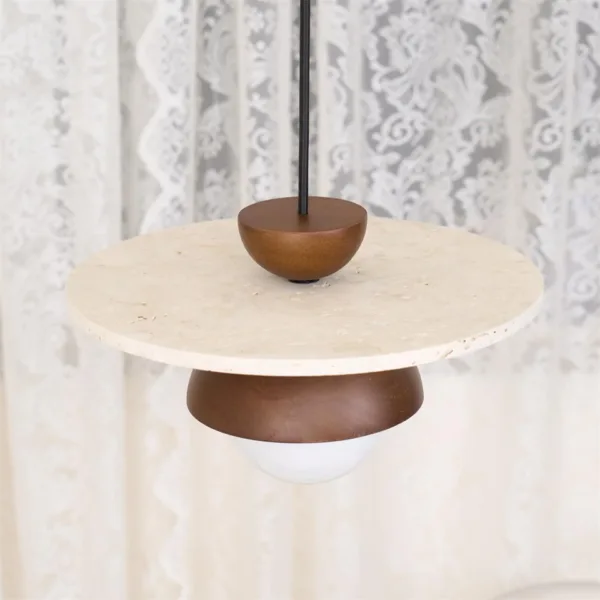 Travertine dome pendant light seen from above: cream travertine disc with a walnut-tone wood cap on a black cord