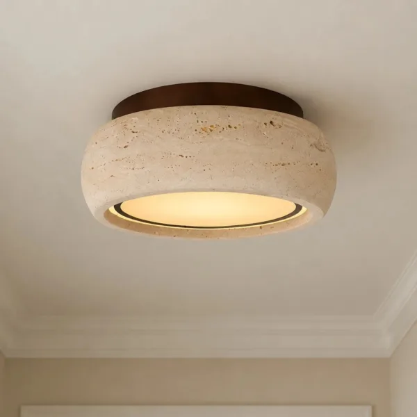 Travertine drum ceiling light glowing from underneath on a white ceiling
