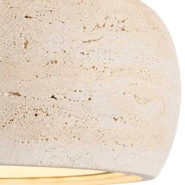 Close-up of honed travertine showing natural pits and cream layers