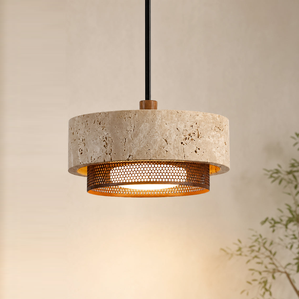 Travertine drum pendant light glowing through its perforated copper-bronze ring in a warm room