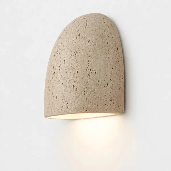 Travertine moon wall light fitted the other way up as a downlight on a white wall