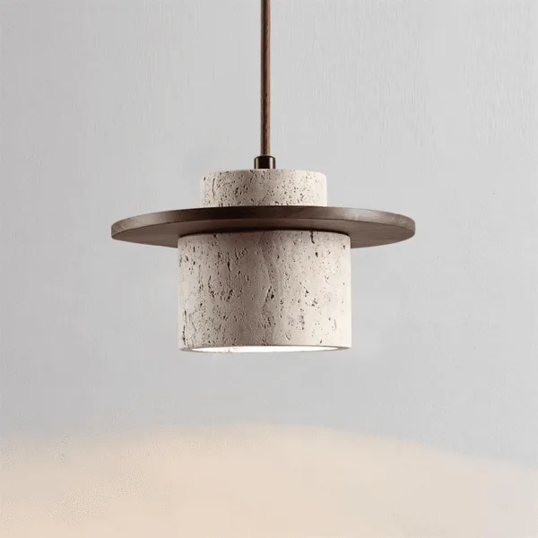 Close view of the travertine pendant light showing open natural pits in the hand-honed stone below the wood disc