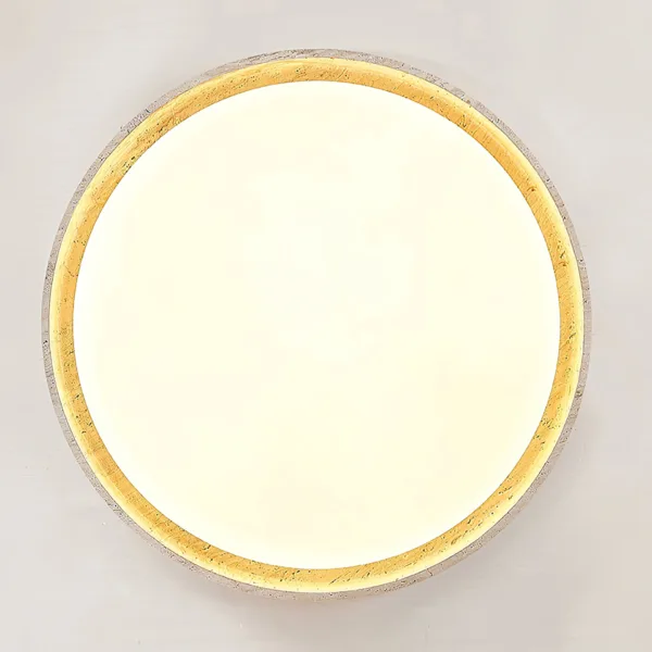 Warm halo inside the travertine ring of the LED ceiling light