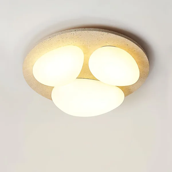 Decorative ceiling light with three glowing pebbles on a travertine disc
