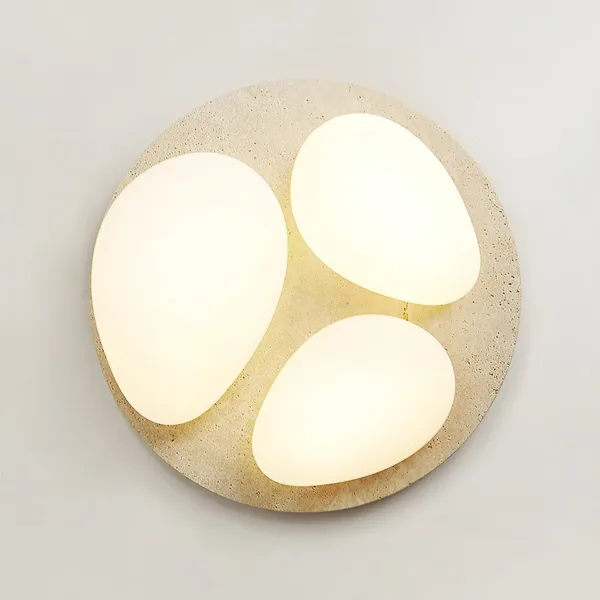 Three pebble diffusers glowing on a round travertine ceiling light