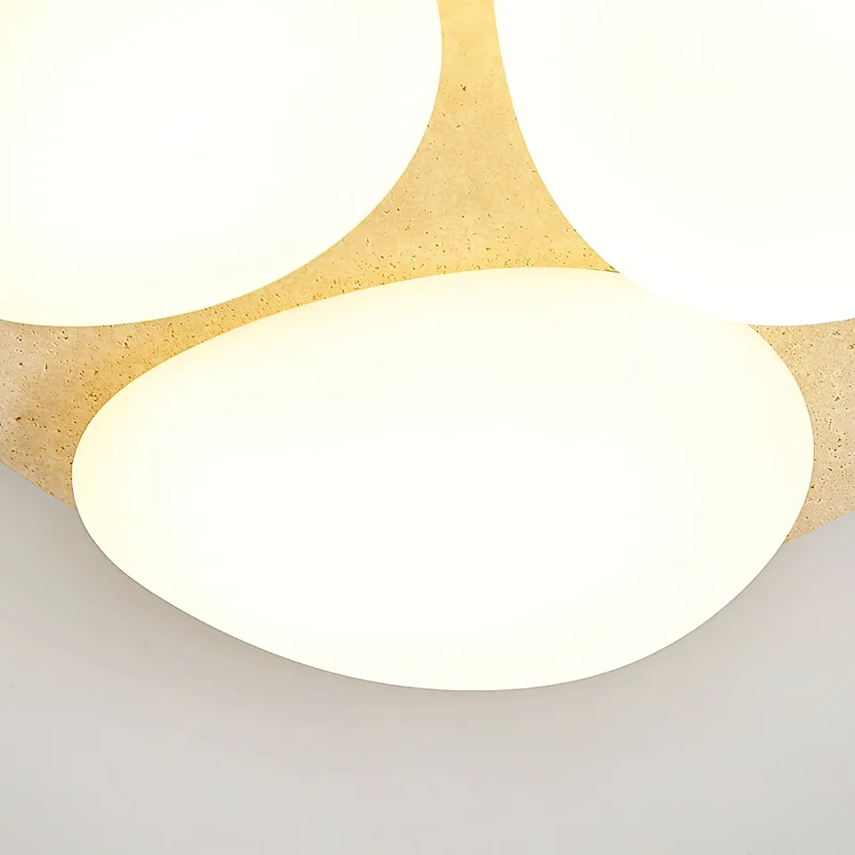 Travertine Ceiling Light – Three Pebble Flush Mount, 50 cm 7 Close-up of a glowing pebble diffuser on honed travertine