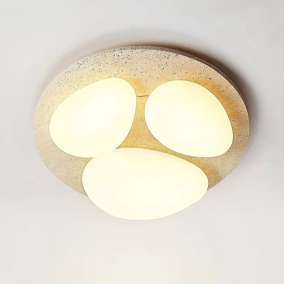 Travertine Ceiling Light – Three Pebble Flush Mount, 50 cm 3 Travertine pebble ceiling light glowing warm, seen at an angle