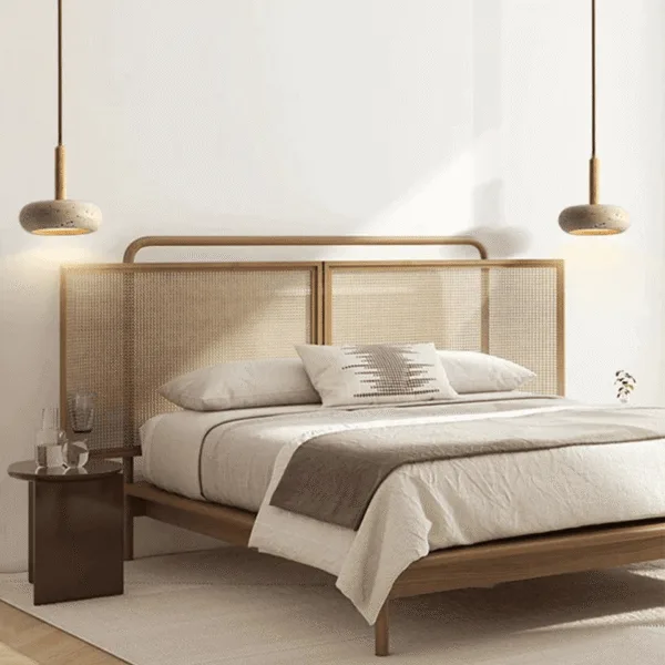 Two travertine pebble pendant lights hung either side of a bed with a cane-webbed headboard