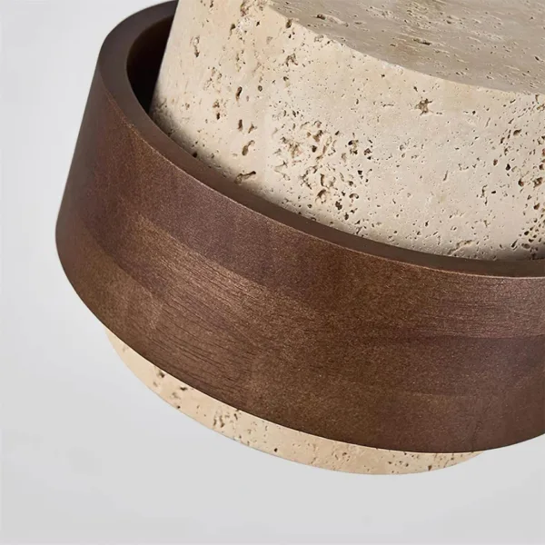 Low view of the travertine and wood pendant light showing the dark wood band and the honed travertine base ring