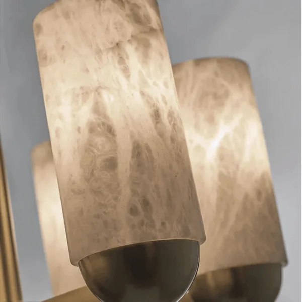 Close-up of a veined natural alabaster cylinder in a brass cup